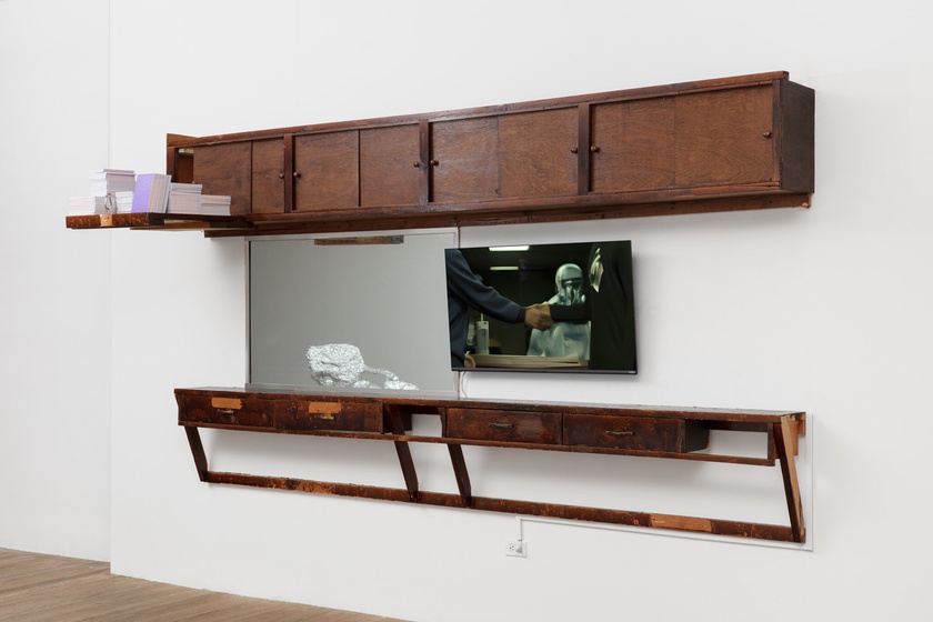 phantom. menace., 2020, 2021, 2022, 2023,  Barbershop fittings, mirror, digital video on monitor, books  71 × 131 × 12 in. (180.34 × 332.74 × 30.48 cm)  video: 3:24 minutes, looped