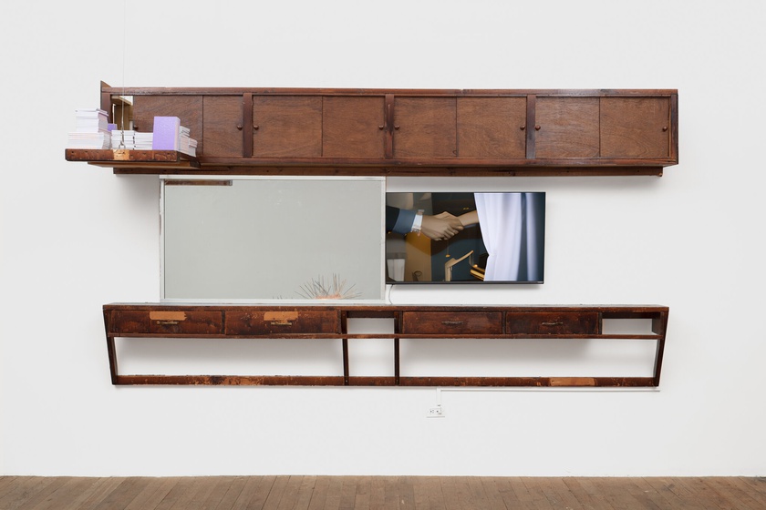 phantom. menace., 2020, 2021, 2022, 2023,  Barbershop fittings, mirror, digital video on monitor, books  71 × 131 × 12 in. (180.34 × 332.74 × 30.48 cm)  video: 3:24 minutes, looped