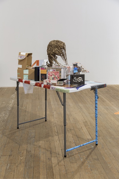 Martine Syms Merch table, 2021 Collapsible table, plastic, metal, indigo prints with adhesive backing, tape 